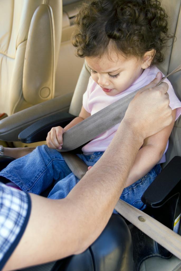 Buckling up a child in a car seat