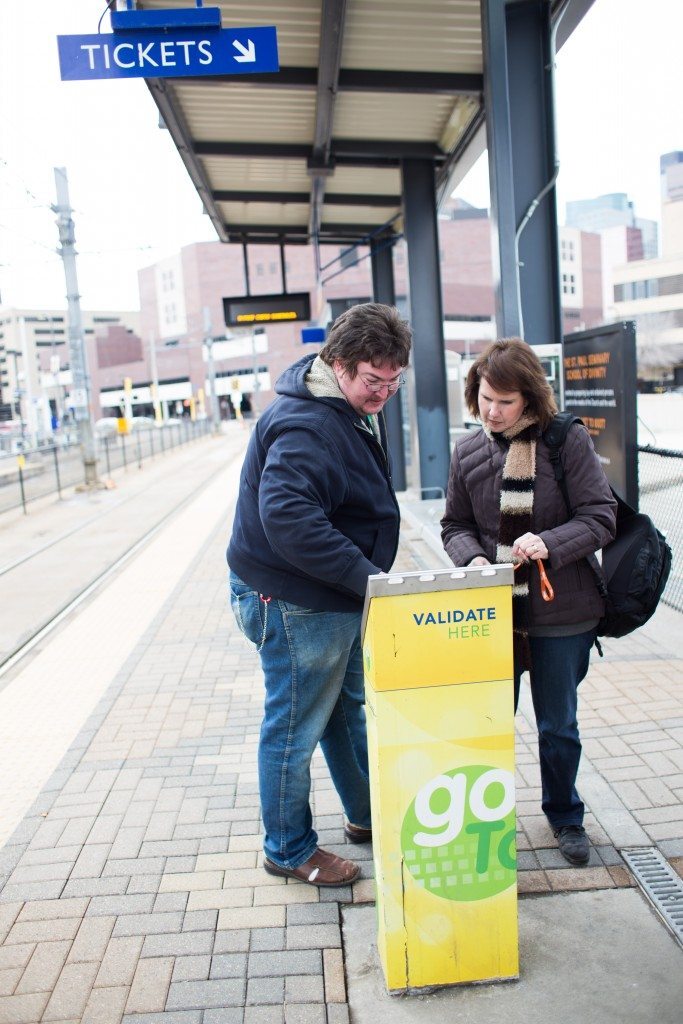 Travel trainer and trainee getting transit tickets