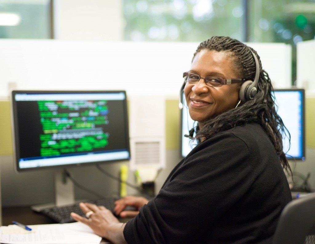 Smiling CSR in front of computer