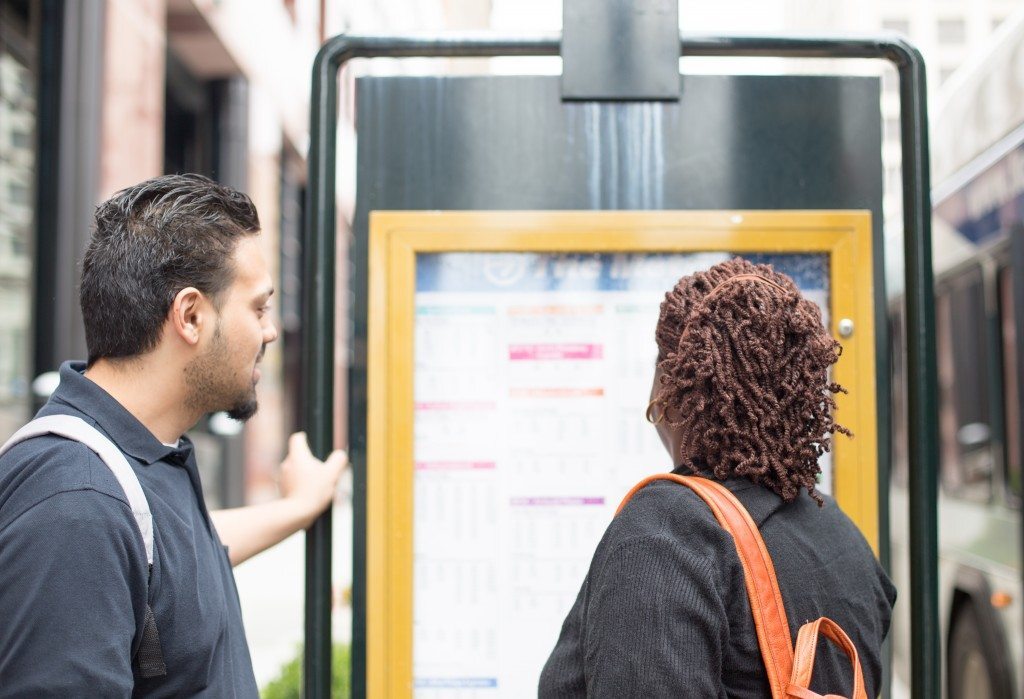 Travel trainer and trainee looking at a bus schedule