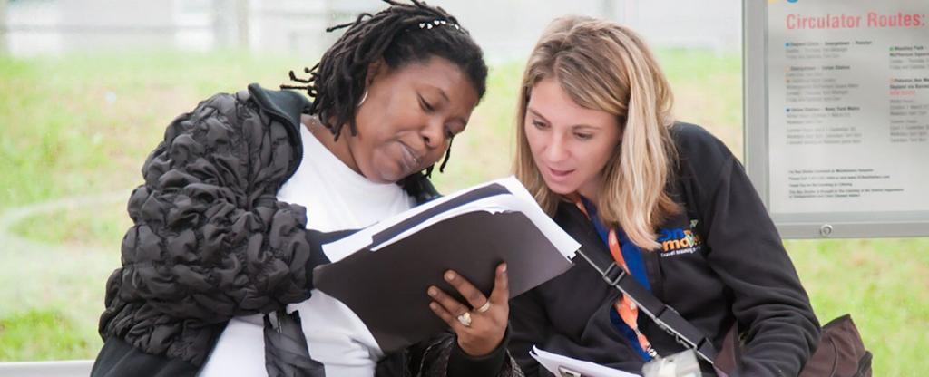 Travel trainer and trainee looking over a map