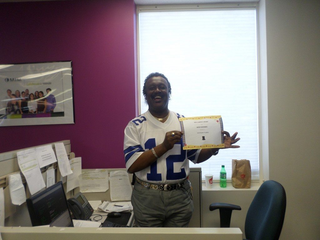 Employee holding 'best of' award