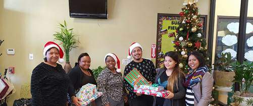 MTM employees with Adopt A Family gifts