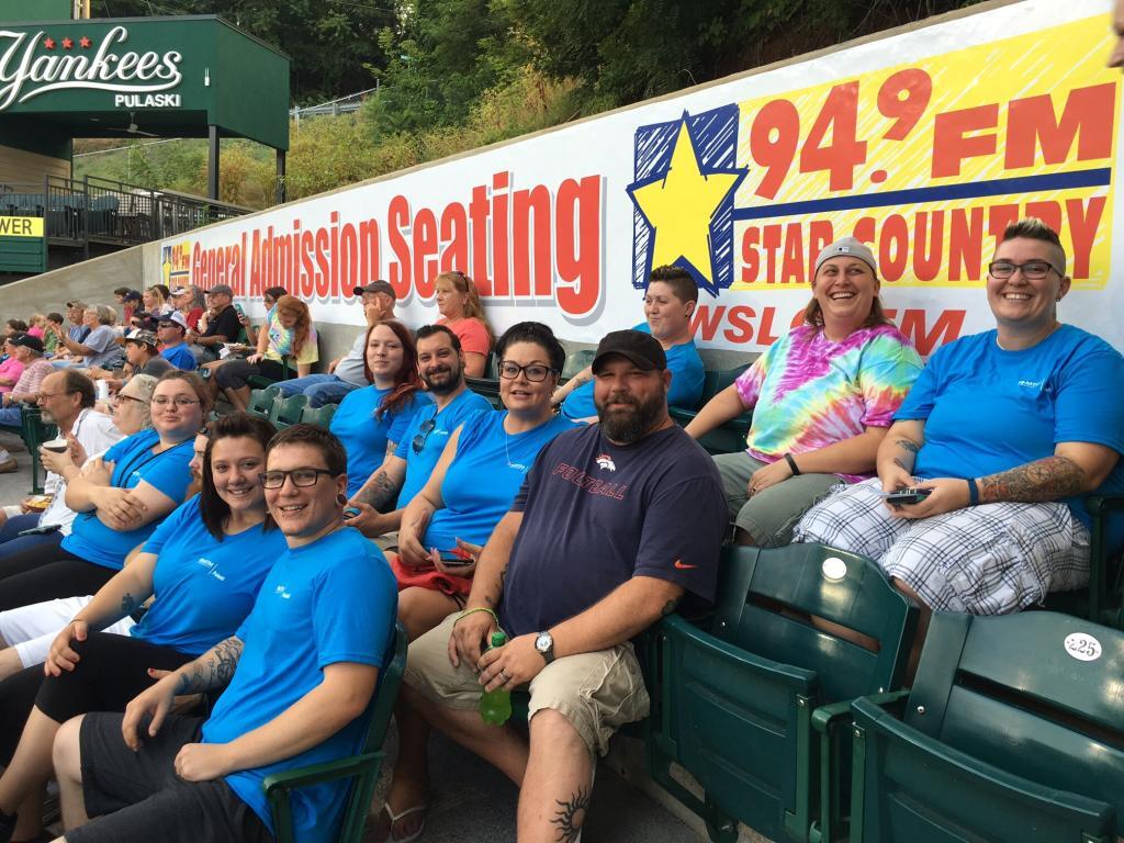 MTM employees celebrating at Cardinal's stadium