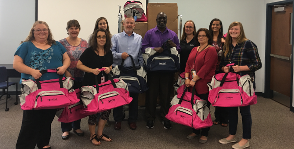 Employees holding the donations to go to foster care