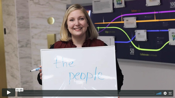 MTM employee holds up a sign showing what her favorite part about working at MTM.