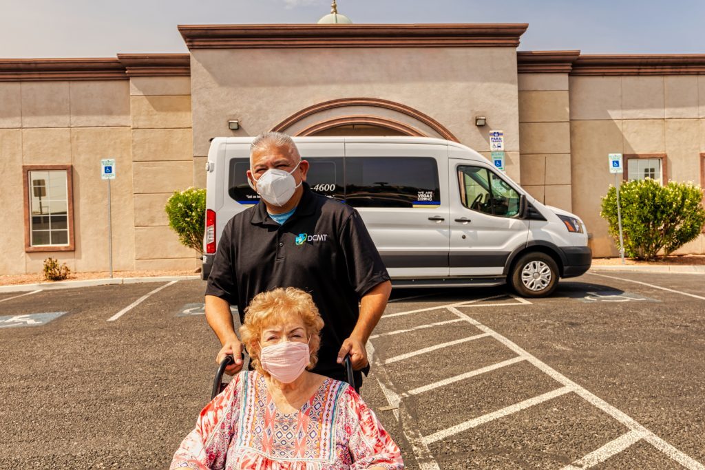 Driver and member in a wheelchair in front of van