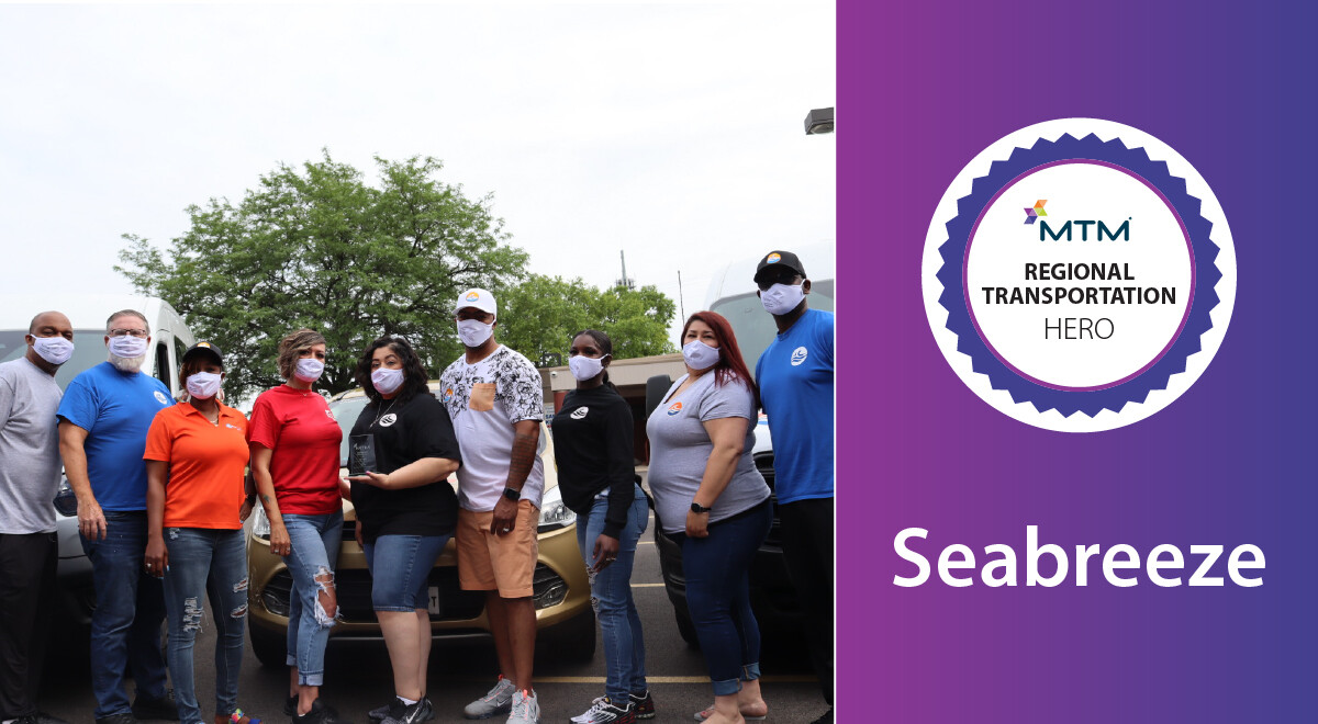 Seabreeze employees hold their Transportation Hero award and celebrate their achievement.