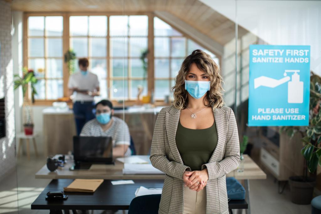 A woman stands in a work office wearing a face covering. MTM takes the health and safety of our teammates and visitors seriously. To prevent the spread of COVID-19 and ensure our employees and visitors remain healthy, we have adopted strict COVID-19 protocol at our headquarters.