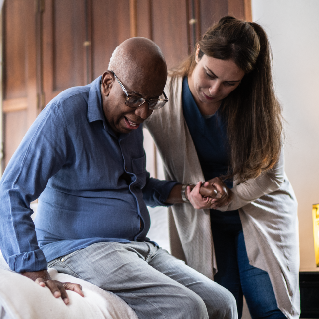 Caretaker helping senior man