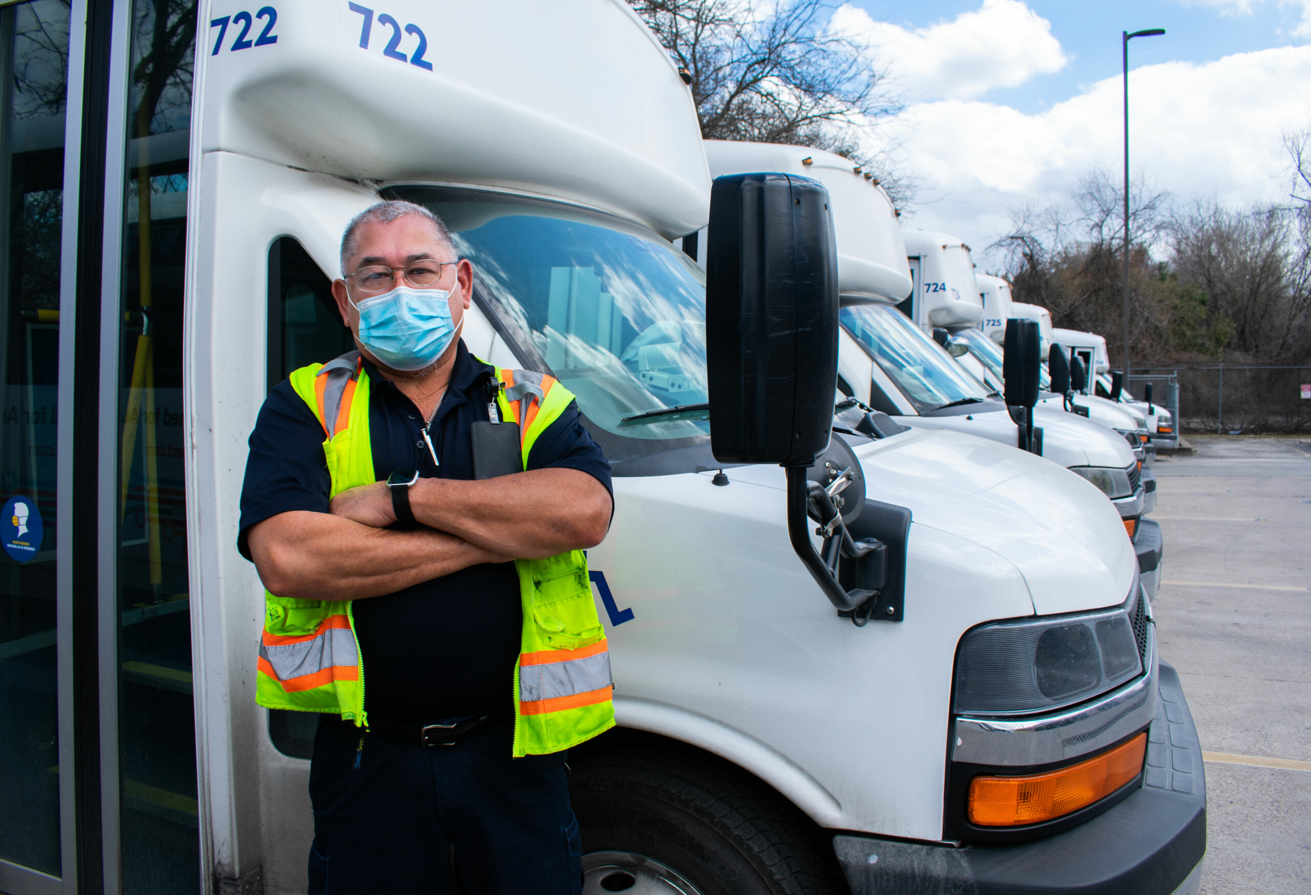 Driver standing in front of his bus