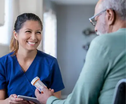 Caretaker and senior patient discussing his prescriptions